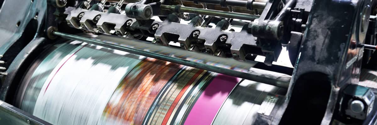 Detail shot of the workings of a printing factory. The commercial designs displayed in this image represent a simulation of a real product and have been changed or altered enough by our team of retouching and design specialists so that they are free of any copyright infringements