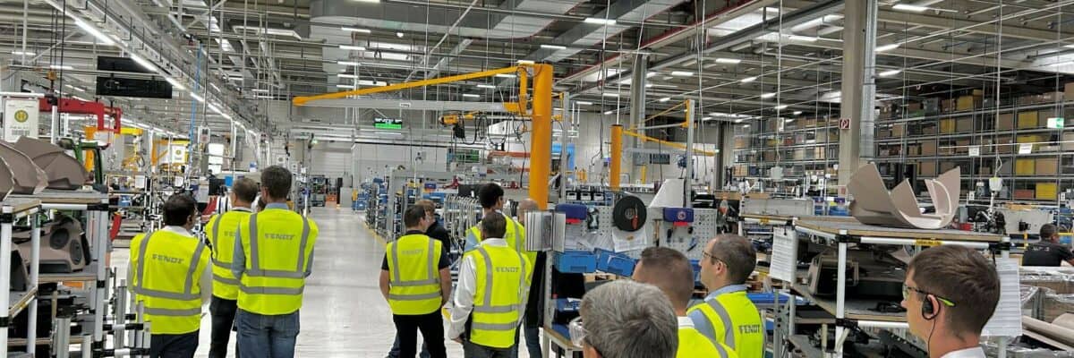 A group of people walking through a factory