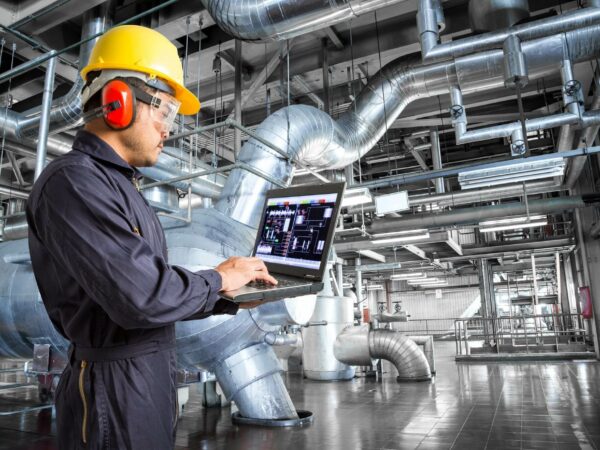 Engineer using laptop computer in factory