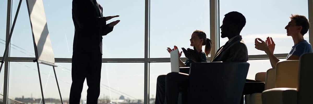 Young managers clapping hands after speech of coach