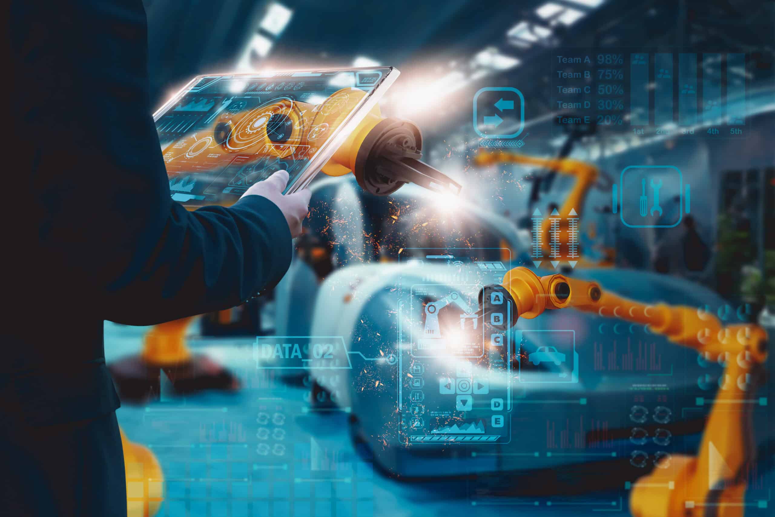 Engineer control automated robot arm Assembly in factory,via smart tablet,automotive industrial,vehicle production line,manufacturing,operation business and industry 4.0,Artificial intelligence or AI