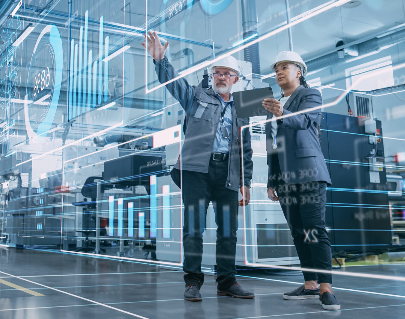 Factory Digitalization: Two Industrial Engineers Use Tablet Computer, Visualize the Wall of Big Data Statistics, Optimization of High-Tech Electronics Facility. Industry 4.0 Machinery Production