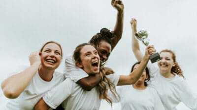 Mannschaft Gewinner Pokal Jubel Diversität