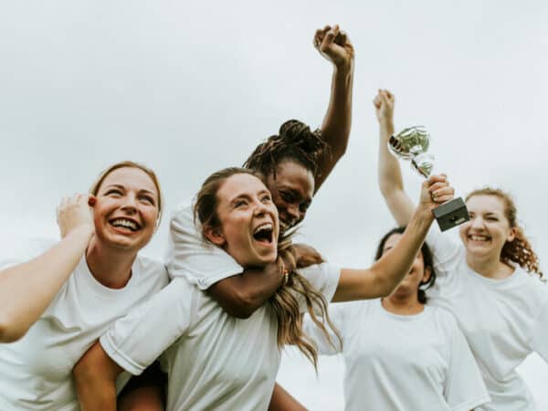Mannschaft Gewinner Pokal Jubel Diversität